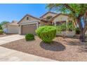 Charming home with a well-manicured front yard, mature landscaping, and a two-car garage at 1701 E Countrywalk Ln, Chandler, AZ 85225