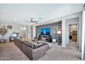 Comfortable living space featuring contemporary décor, a ceiling fan, and a TV at 18394 W Lupine Ave, Goodyear, AZ 85338