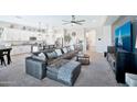 Spacious living room with a modern open layout concept, including a view of the kitchen at 18394 W Lupine Ave, Goodyear, AZ 85338