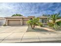 Beautiful home with a two-car garage, desert landscaping, and stone pathway at 1893 W Canary Way, Chandler, AZ 85286