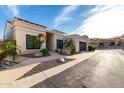 Charming single-story home with desert landscaping and a modern garage door under a blue sky at 21 W Beryl Ave, Phoenix, AZ 85021