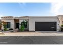 Charming single-story home with desert landscaping and a modern garage door under a blue sky at 21 W Beryl Ave, Phoenix, AZ 85021