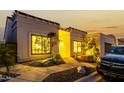 Attractive single-story home with desert landscaping and a paved walkway at twilight at 21 W Beryl Ave, Phoenix, AZ 85021