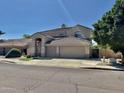 Beautiful stucco home featuring a 3-car garage and desert landscaping at 2461 E Binner Dr, Chandler, AZ 85225