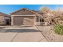 Charming single-story home with a two-car garage and neat desert landscaping at 2738 E Silversmith Trl, San Tan Valley, AZ 85143