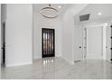 Bright entryway featuring light marble floors and a stylish black door at 28341 N 112Th Way, Scottsdale, AZ 85262