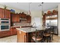 Beautiful kitchen featuring an island with seating, stainless steel appliances, and ample cabinet space at 3373 E Sports Dr, Gilbert, AZ 85298