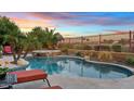 A resort-style pool and spa surrounded by lush landscaping and comfortable lounge chairs at 3373 E Sports Dr, Gilbert, AZ 85298