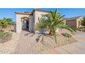 Inviting home entrance with a well-manicured yard and a charming walkway at 36169 N Serrano Ave, Queen Creek, AZ 85140