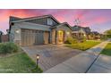 Attractive home with a well-maintained lawn, stone accents, and a brick driveway leading to a two-car garage at 3859 E Appaloosa Rd, Gilbert, AZ 85296