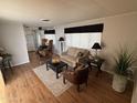 Cozy living room with wood-style flooring, comfortable seating, and natural light, creating an inviting atmosphere at 4065 E University Dr # 88, Mesa, AZ 85205