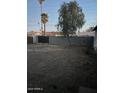 A large backyard features a block fence and mature landscaping at 4301 N 72Nd Ln, Phoenix, AZ 85033