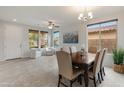 Open dining area with tiled flooring, a chandelier and natural light, perfect for Gathering gatherings at 608 E Pasaro Dr, Phoenix, AZ 85085