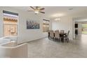 Bright dining area with neutral walls, tiled floors, and a view to the outdoor living space at 608 E Pasaro Dr, Phoenix, AZ 85085