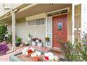 Welcoming front porch adorned with colorful potted flowers, offering a charming curb appeal at 6118 N 12Th Pl # 2, Phoenix, AZ 85014
