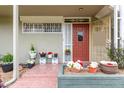 Inviting front porch with tiled landing, decorative ironwork, and potted plants and flowers at 6118 N 12Th Pl # 2, Phoenix, AZ 85014