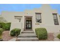 The front entrance features a wooden shutter door and neatly trimmed landscaping leading up the slate-tiled stairs at 6278 N 31St Way, Phoenix, AZ 85016