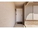 Inviting front entrance with a classic white door, decorative lighting, and a 'Welcome' mat at 7310 E Dewberry Ave, Mesa, AZ 85208