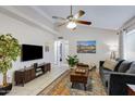 Cozy living room featuring vaulted ceilings, neutral paint, stylish furnishings, and great natural light at 7310 E Dewberry Ave, Mesa, AZ 85208