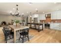 Open-concept kitchen and dining area, showcasing stainless steel appliances, island, and adjacent living space with fireplace at 8361 E Via De Viva --, Scottsdale, AZ 85258