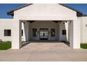 Inviting front entrance with black framed windows, and tile flooring leads to the home's interior at 10620 N 84Th St, Scottsdale, AZ 85260