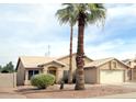 Inviting single-story home with desert landscaping, a two-car garage, and mature palm trees in the front yard at 1132 E Harbor View Dr, Gilbert, AZ 85234