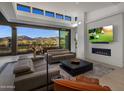 Open living room with a fireplace, TV, couches and view of the mountains at 37200 N Cave Creek Rd # 2108, Scottsdale, AZ 85262
