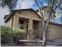 Two-story home featuring a neutral stucco exterior, tile roof, and a well-maintained front yard at 4152 S 249Th Dr, Buckeye, AZ 85326