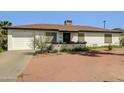 Charming single-story home with desert landscaping, window trim, and a driveway at 10245 N 15Th Dr, Phoenix, AZ 85021