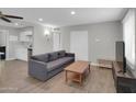 Inviting living room features tile floors, gray sofa, and modern furnishings at 10245 N 15Th Dr, Phoenix, AZ 85021