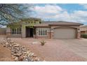 Beautiful single-story home featuring a spacious driveway, desert landscaping, and a two-car garage at 10423 E Verbena Ln, Scottsdale, AZ 85255