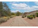 Charming home featuring desert landscaping, a winding walkway, and scenic mountain views at 10423 E Verbena Ln, Scottsdale, AZ 85255