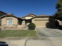 Attractive single-level house featuring a well-maintained lawn, neutral paint, and an attached two-car garage at 11570 W Pima St, Avondale, AZ 85323