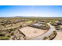 Expansive aerial shot displays surrounding desert community and golf course creating a picturesque landscape at 12053 W Palo Brea Ln, Peoria, AZ 85383