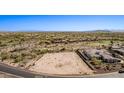 Vast aerial view showcases available lot with neighborhood, golf course and desert mountain views at 12053 W Palo Brea Ln, Peoria, AZ 85383