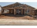 Exterior view of home under construction with framing, windows and garage ready for finishing at 15777 W Cheryl Dr, Waddell, AZ 85355