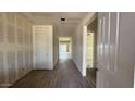 Spacious hallway with hard wood floors, leading to open rooms with abundant light at 15777 W Cheryl Dr, Waddell, AZ 85355
