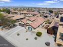 Charming single-story home featuring a tile roof, neutral stucco, a two-car garage, and low-maintenance desert landscaping at 16438 W Buchanan St, Goodyear, AZ 85338