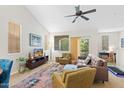 Well-lit living room features a ceiling fan, neutral-toned furniture, and a view to the outdoor balcony at 1920 E Bell Rd # 1034, Phoenix, AZ 85022