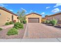 Charming home featuring a brick driveway, well-maintained landscaping, and a two-car garage in a desirable community at 2041 N 88Th St, Mesa, AZ 85207