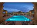 Stunning community pool with ample seating and mountain views, perfect for relaxation and recreation at 2041 N 88Th St, Mesa, AZ 85207
