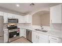 Modern kitchen featuring white cabinets, stainless steel appliances, and white quartz countertops at 20449 N 105Th Ave, Peoria, AZ 85382