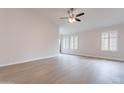 Bright living room featuring contemporary flooring, recessed lighting and plantation shutters on the large windows at 20449 N 105Th Ave, Peoria, AZ 85382