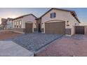 Single-story home showcasing a brick-accented facade, a paved driveway, and a warm, inviting aesthetic at 2636 E Virginia St, Mesa, AZ 85213