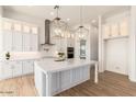Stylish kitchen featuring white cabinets, quartz countertops, and pendant lighting at 2636 E Virginia St, Mesa, AZ 85213