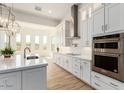 Modern kitchen with white cabinets, stainless steel appliances and large island at 2636 E Virginia St, Mesa, AZ 85213