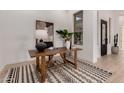 Bright office space featuring a stylish desk, neutral decor, modern lamp, and a view to the courtyard at 2636 E Virginia St, Mesa, AZ 85213