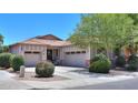 Charming single-story home with a well-manicured lawn, three-car garage, and inviting curb appeal at 271 W Key West W Dr, Casa Grande, AZ 85122