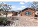 Beautiful single-Gathering house with desert landscaping, brick accents, and a well-maintained front yard at 40020 N Cape Wrath Dr Dr, San Tan Valley, AZ 85140