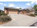 Attractive one-story home with brick accents, a two-car garage, and a spacious concrete driveway at 40020 N Cape Wrath Dr Dr, San Tan Valley, AZ 85140